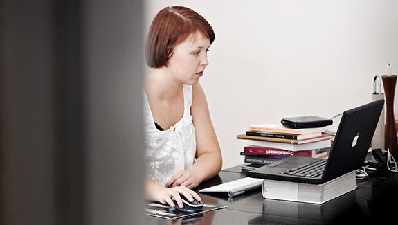 woman-working-on-computer-at-desk-going-back-to-work-after-an-ostomy-procedure